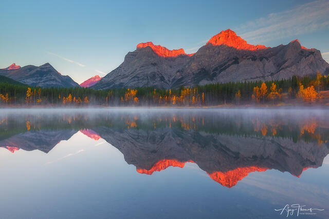 Alpine glow and mirror reflection in a still lake 