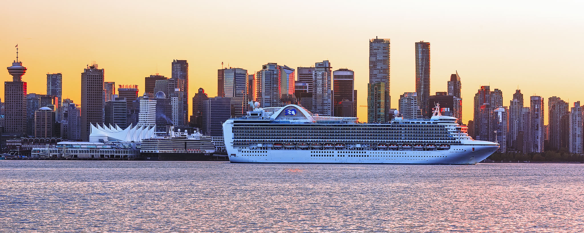 Vancouver skyline sunset with Cruise ship leaving the port 