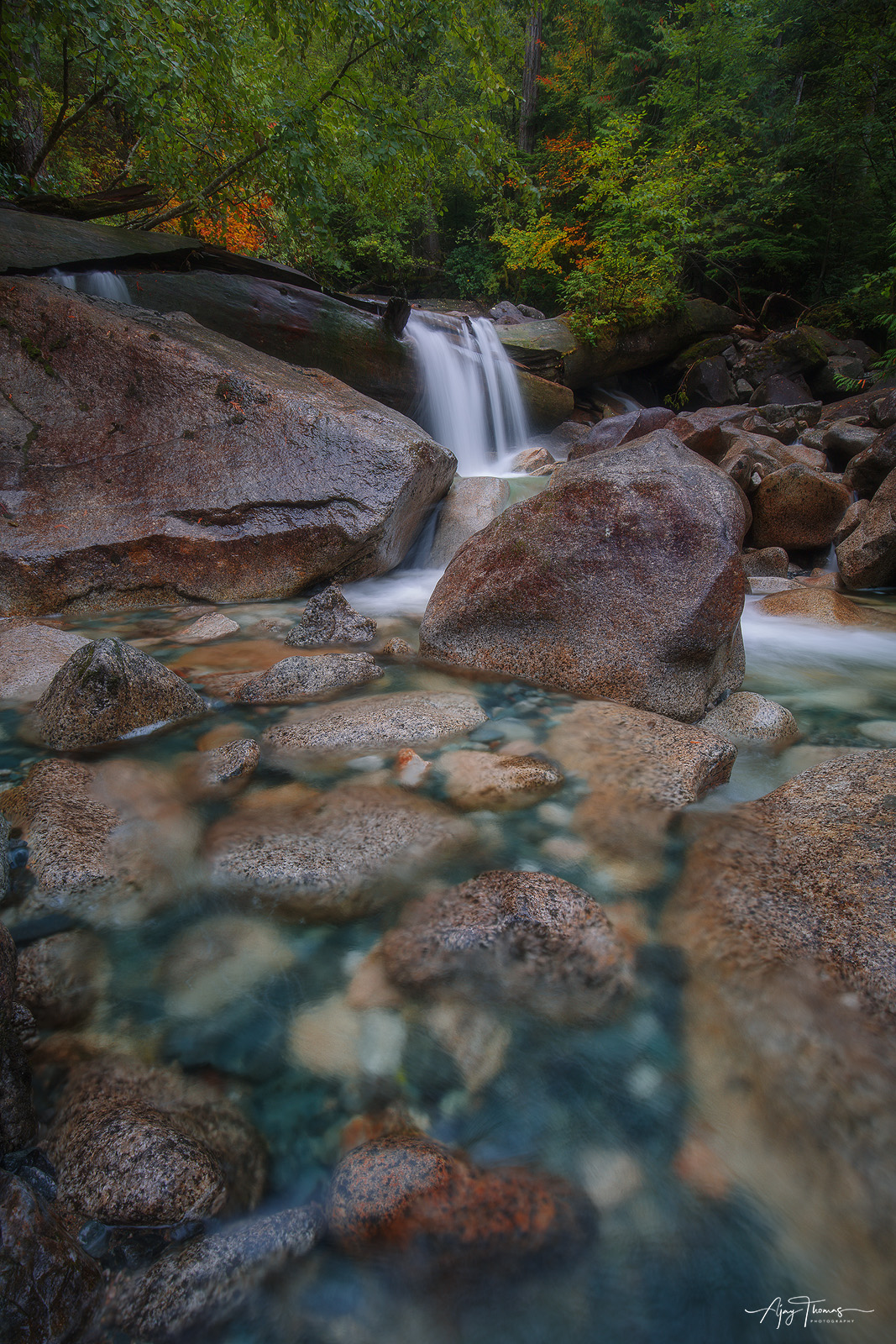 A delicate balance between the raw power of waterfalls and the strength of the surrounding rocky terrain, showcasing the harmony...