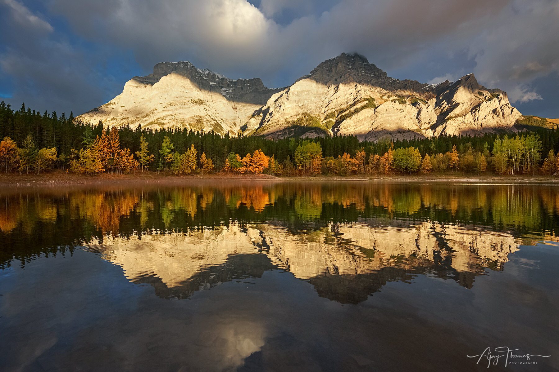 Mountain reflection in a still lake during sunrise 