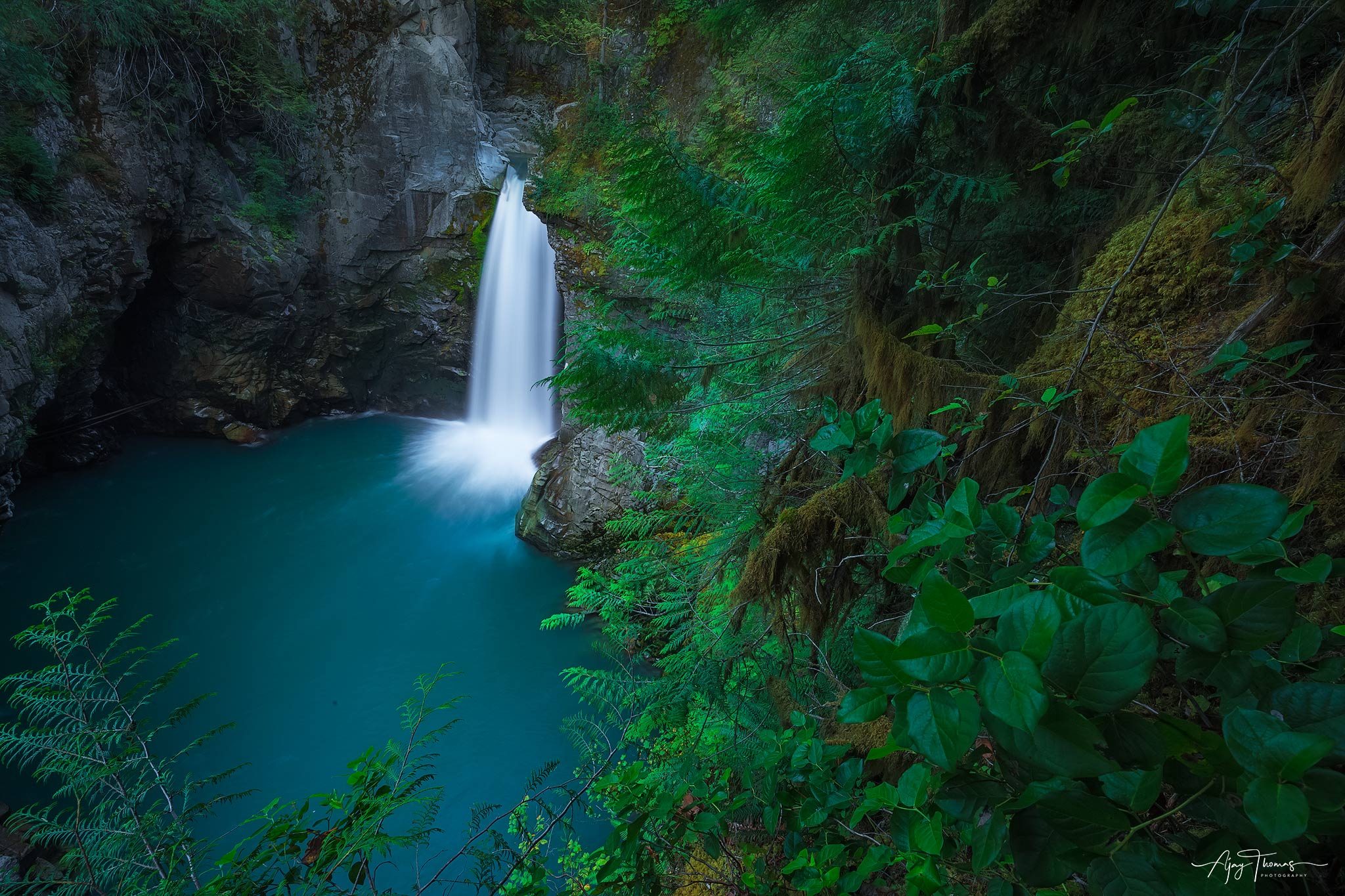 Forest waterfalls with aqua blue water