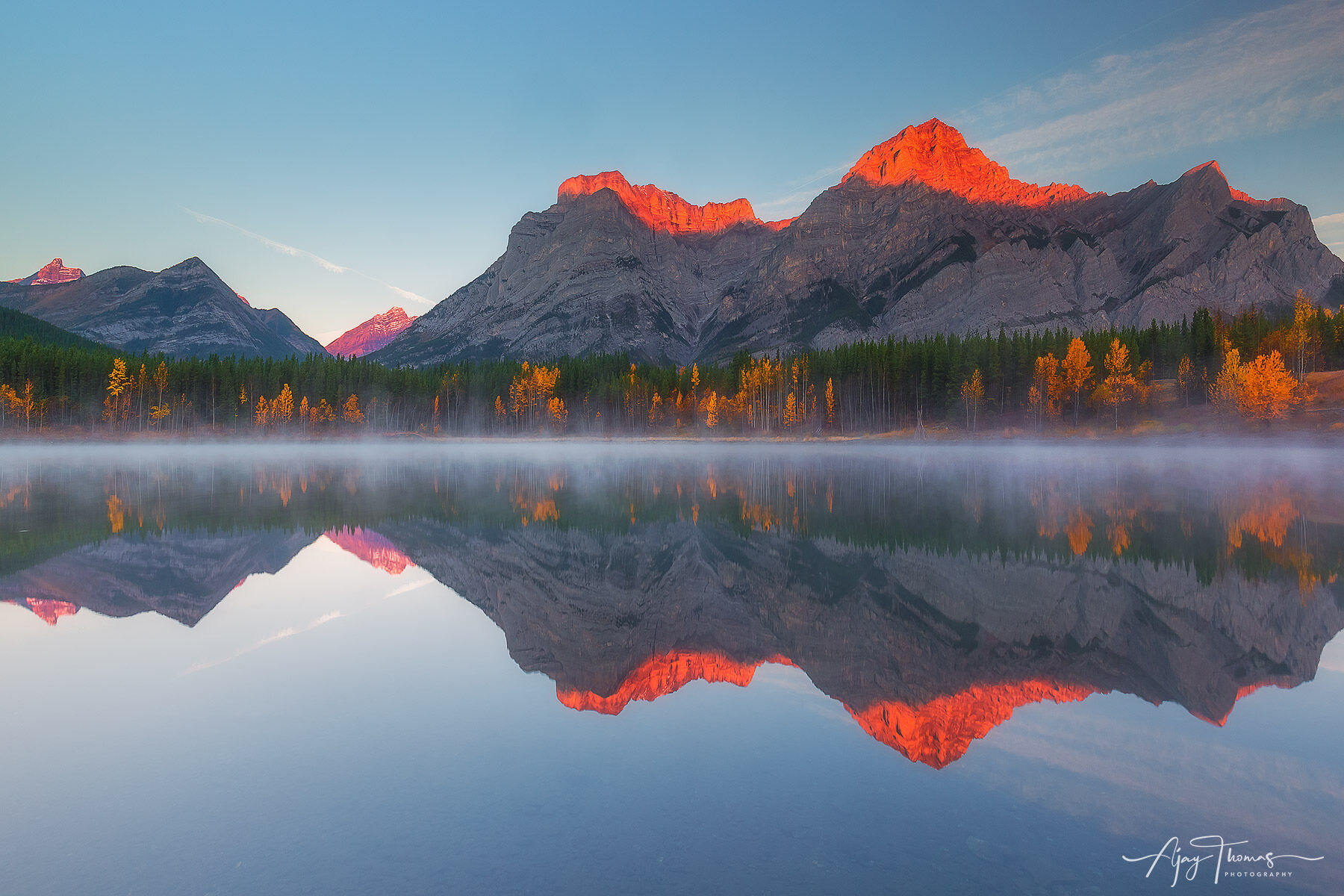 Alpine glow and mirror reflection in a still lake 